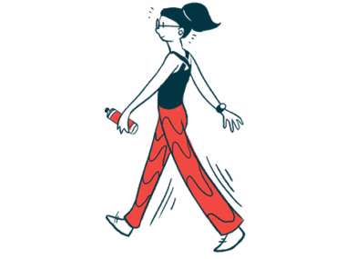 A woman is walking while holding a water bottle.