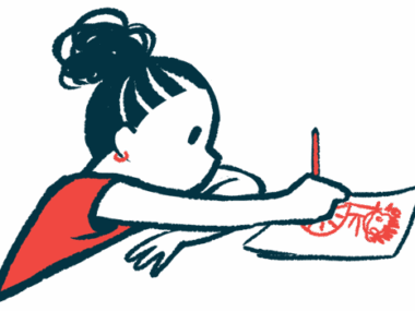 A girl sits at a table and draws.