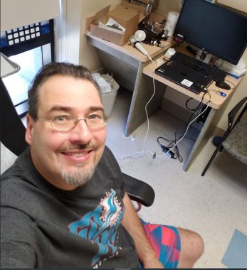 pompe disease diagnosis | Pompe Disease News | Dwayne sits in the doctor's office getting ready for a breathing test. He's looking up at the camera, selfie-style, and smiling