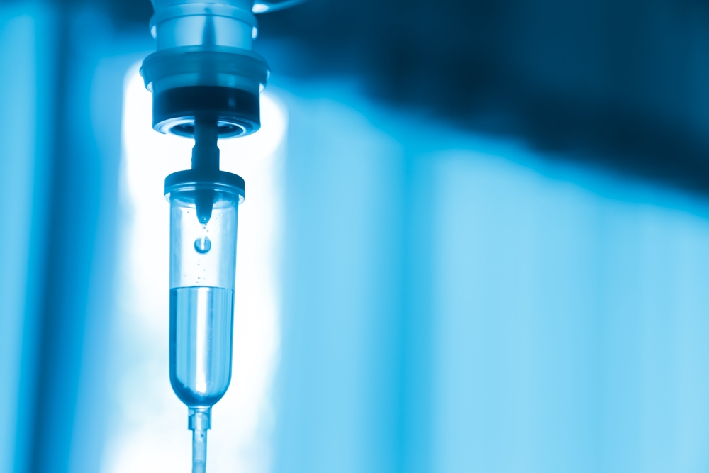 an IV drip on a blue background