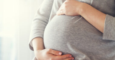 A pregnant woman holding her belly