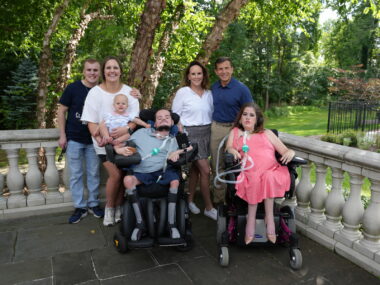 Crowley family standing in front of trees