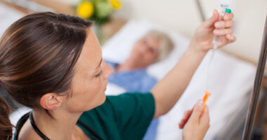 A healthcare provider preparing to give an infusion to a patient.