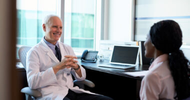 A doctor consulting with a female patient