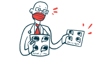 A doctor wearing a face mask speaks as he holds a pair of charts.