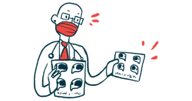 A doctor wearing a face mask speaks as he holds a pair of charts.