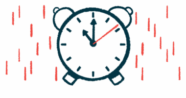 An analog alarm clock indicating 11 o'clock.