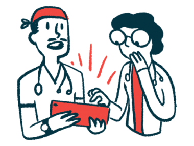 Two doctors consult with each other while looking at a tablet.