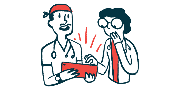 Two doctors consult with each other while looking at a tablet.